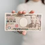 hand holding japanese yen banknote stack thousand 2023 11 27 05 19 02 utc